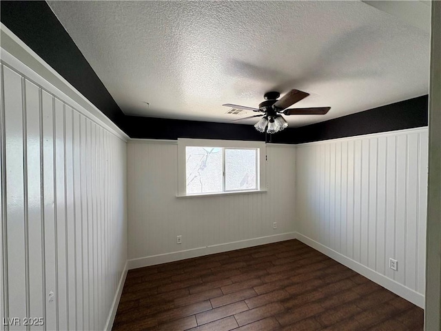 8237 Cline Mountain St, Las Vegas, NV 89131 - spare room with dark wood finished floors, a textured ceiling, a ceiling fan, and baseboards