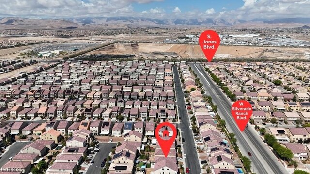 5661 Brimstone Hill Ave, Las Vegas, NV 89141 - aerial view of property and surrounding area with nearby suburban area and a mountainous background