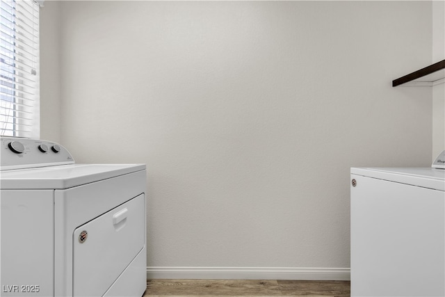 5661 Brimstone Hill Ave, Las Vegas, NV 89141 - washroom with washer and clothes dryer, light wood finished floors, and baseboards
