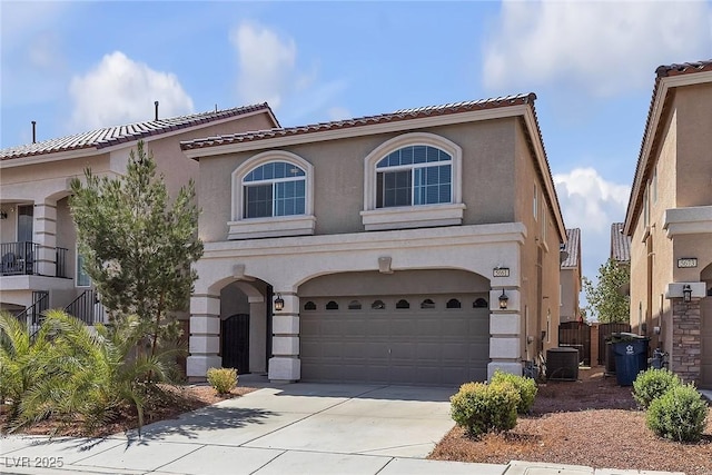 5661 Brimstone Hill Ave, Las Vegas, NV 89141 - view of front of home with an attached garage, concrete driveway, stucco siding, and a tiled roof
