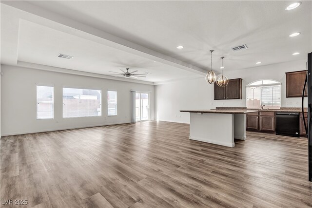 5661 Brimstone Hill Ave, Las Vegas, NV 89141 - unfurnished living room featuring recessed lighting, wood finished floors, ceiling fan, a chandelier, and a sink