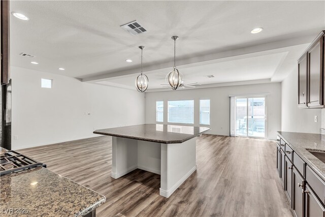 5661 Brimstone Hill Ave, Las Vegas, NV 89141 - kitchen with open floor plan, light wood finished floors, plenty of natural light, a chandelier, and recessed lighting