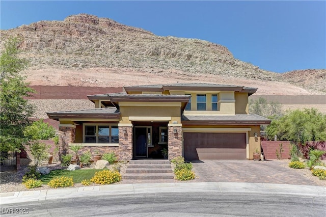 5635 Mesa Mountain Dr, Las Vegas, NV 89135 - prairie-style home with stucco siding, a mountain view, a garage, and decorative driveway