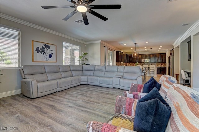 5635 Mesa Mountain Dr, Las Vegas, NV 89135 - living area featuring plenty of natural light, baseboards, ornamental molding, light wood-style flooring, and a ceiling fan
