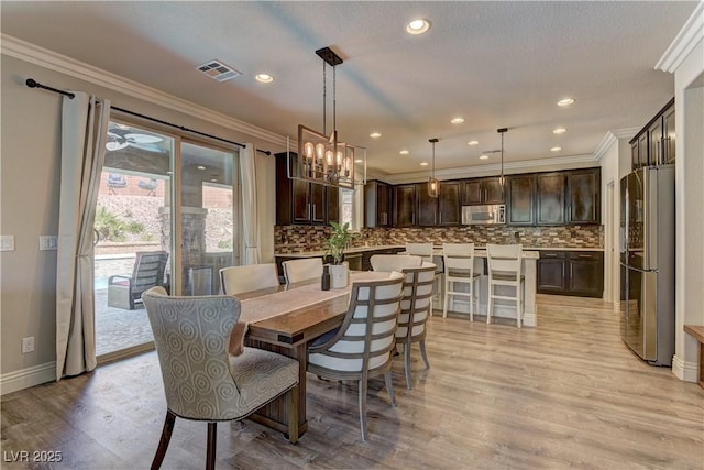 5635 Mesa Mountain Dr, Las Vegas, NV 89135 - dining space featuring ornamental molding, light wood-style flooring, a chandelier, recessed lighting, and baseboards