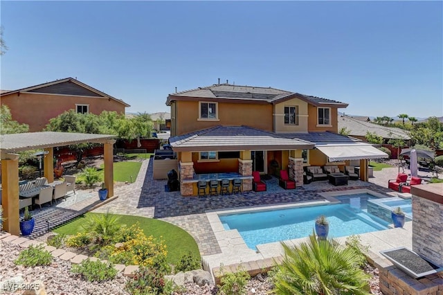 5635 Mesa Mountain Dr, Las Vegas, NV 89135 - rear view of property with an outdoor hangout area, a patio, stucco siding, and a pool with connected hot tub