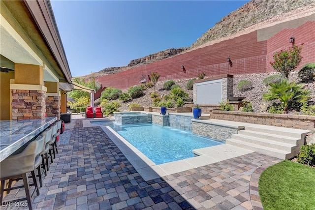 5635 Mesa Mountain Dr, Las Vegas, NV 89135 - view of swimming pool with a patio, a bar, and a pool with connected hot tub