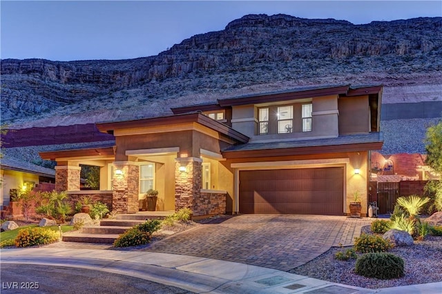 5635 Mesa Mountain Dr, Las Vegas, NV 89135 - view of front of house featuring a mountain view, an attached garage, stucco siding, and decorative driveway