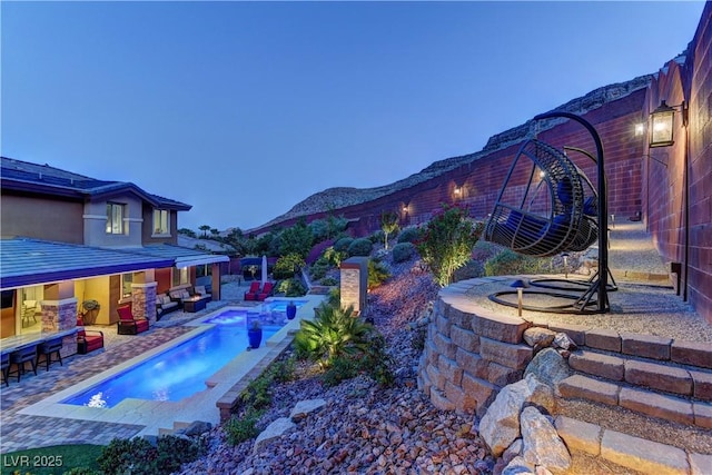 5635 Mesa Mountain Dr, Las Vegas, NV 89135 - view of pool featuring an outdoor living space, a patio, an outdoor bar, a pool with connected hot tub, and a fenced backyard