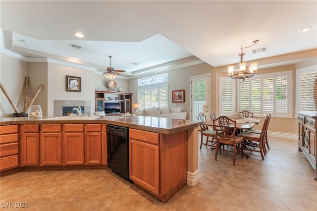 11405 Perugino Dr, Las Vegas, NV 89138 - kitchen featuring dishwasher, a warm lit fireplace, a chandelier, brown cabinetry, and ornamental molding