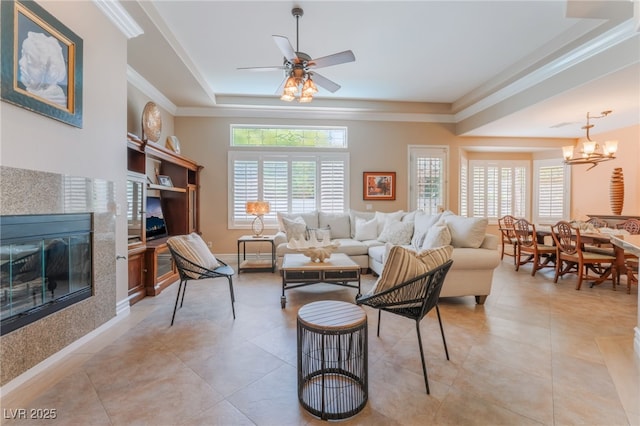11405 Perugino Dr, Las Vegas, NV 89138 - living area with a tile fireplace, a tray ceiling, ornamental molding, ceiling fan, and light tile patterned floors