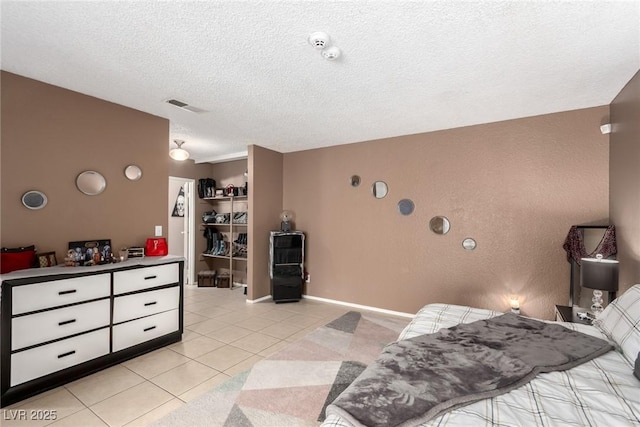 4213 Essex Green Ct, Las Vegas, NV 89110 - bedroom featuring light tile patterned floors, a textured ceiling, and a spacious closet