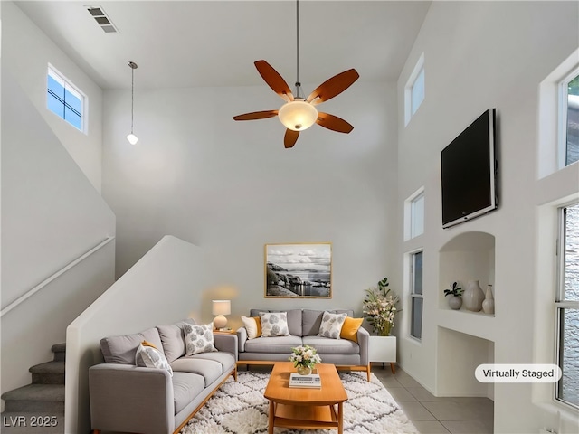7900 Wood Shadow Ct, Las Vegas, NV 89131 - living room with a high ceiling, a ceiling fan, light tile patterned floors, and stairway