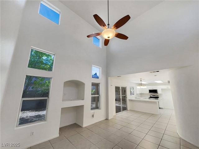 7900 Wood Shadow Ct, Las Vegas, NV 89131 - unfurnished living room with a high ceiling, a ceiling fan, a sink, light tile patterned flooring, and a chandelier