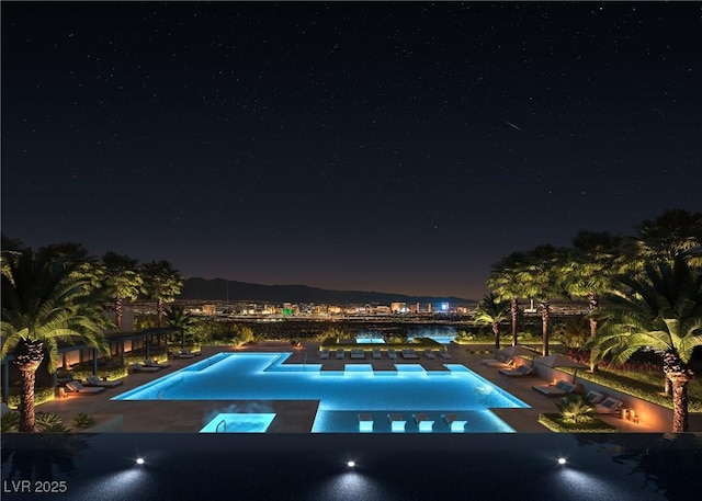 410 Rock Peak Dr Unit 1704, Henderson, NV 89012 - pool at night with a pool with connected hot tub and a patio area