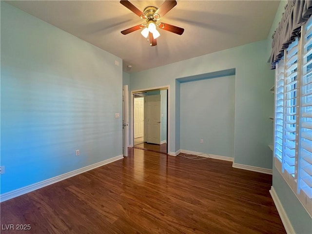 2343 Scotch Lake St, Las Vegas, NV 89134 - unfurnished bedroom with dark wood-style flooring, baseboards, and a ceiling fan