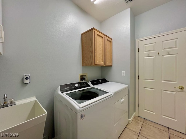 2343 Scotch Lake St, Las Vegas, NV 89134 - laundry room featuring separate washer and dryer, light tile patterned flooring, and cabinet space