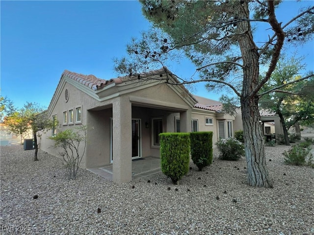 2343 Scotch Lake St, Las Vegas, NV 89134 - view of property exterior featuring stucco siding, a tile roof, and central AC