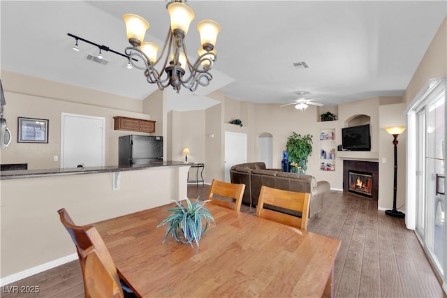 5000 Red Rock St Unit 259, Las Vegas, NV 89118 - dining room with a tile fireplace, hardwood / wood-style flooring, a chandelier, a ceiling fan, and built in features
