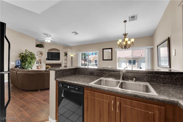 5000 Red Rock St Unit 259, Las Vegas, NV 89118 - kitchen featuring black dishwasher, a sink, dark countertops, ceiling fan, and brown cabinetry
