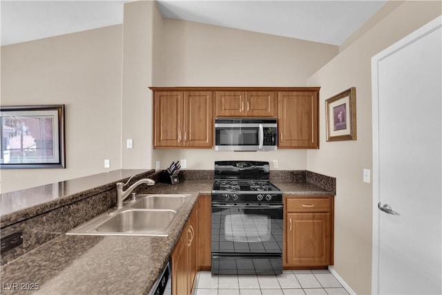 5000 Red Rock St Unit 259, Las Vegas, NV 89118 - kitchen featuring stainless steel microwave, black gas range oven, a sink, dark countertops, and brown cabinetry