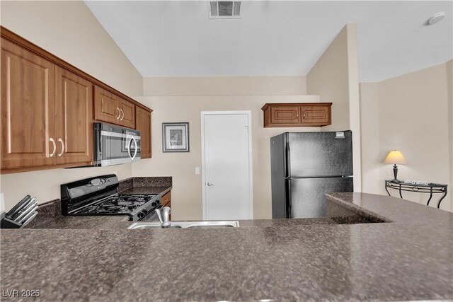 5000 Red Rock St Unit 259, Las Vegas, NV 89118 - kitchen featuring gas range, freestanding refrigerator, stainless steel microwave, and dark countertops