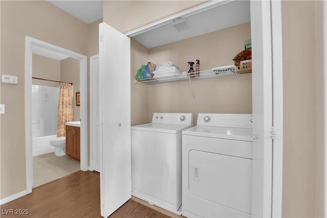 5000 Red Rock St Unit 259, Las Vegas, NV 89118 - laundry area featuring independent washer and dryer, light wood-type flooring, and baseboards