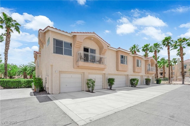5000 Red Rock St Unit 259, Las Vegas, NV 89118 - mediterranean / spanish-style house featuring an attached garage, stucco siding, driveway, and a tile roof