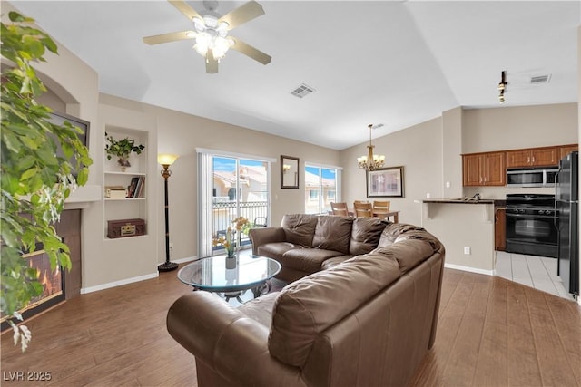 5000 Red Rock St Unit 259, Las Vegas, NV 89118 - living room with lofted ceiling, light wood-style flooring, a chandelier, ceiling fan, and baseboards