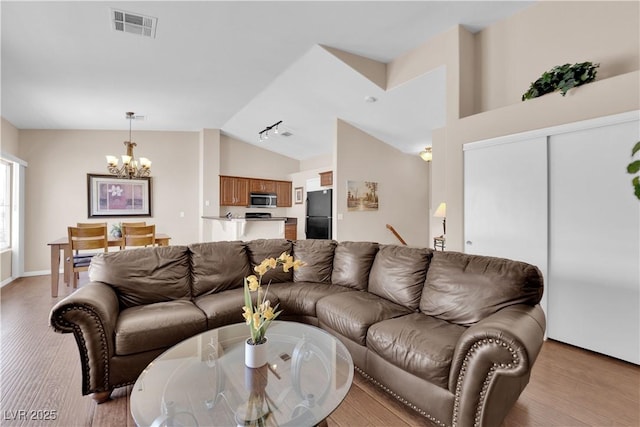 5000 Red Rock St Unit 259, Las Vegas, NV 89118 - living area featuring a chandelier, light wood finished floors, and high vaulted ceiling