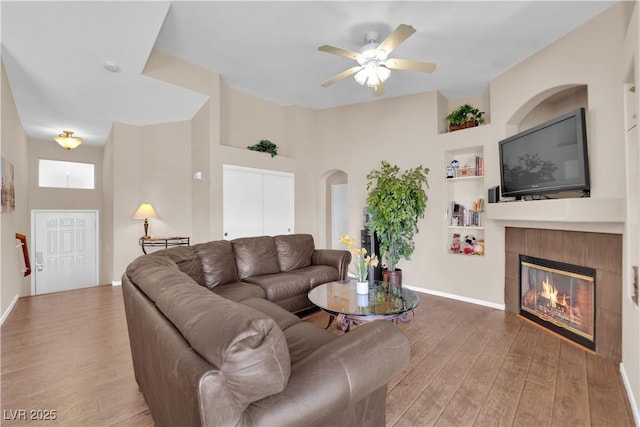 5000 Red Rock St Unit 259, Las Vegas, NV 89118 - living area featuring wood finished floors, a fireplace, built in features, and a ceiling fan