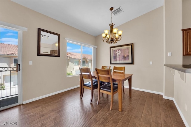 5000 Red Rock St Unit 259, Las Vegas, NV 89118 - dining area featuring a chandelier, dark wood finished floors, and baseboards