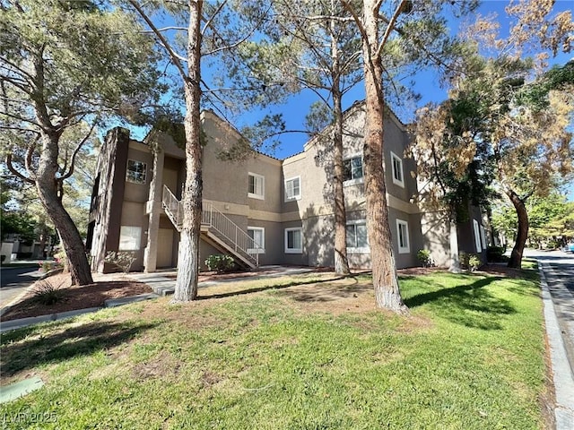 5250 S Rainbow Blvd Unit 2029, Las Vegas, NV 89118 - back of property with stairs, a yard, and stucco siding