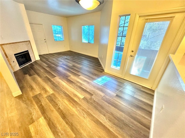 5250 S Rainbow Blvd Unit 2029, Las Vegas, NV 89118 - unfurnished living room with wood finished floors, a fireplace, and baseboards
