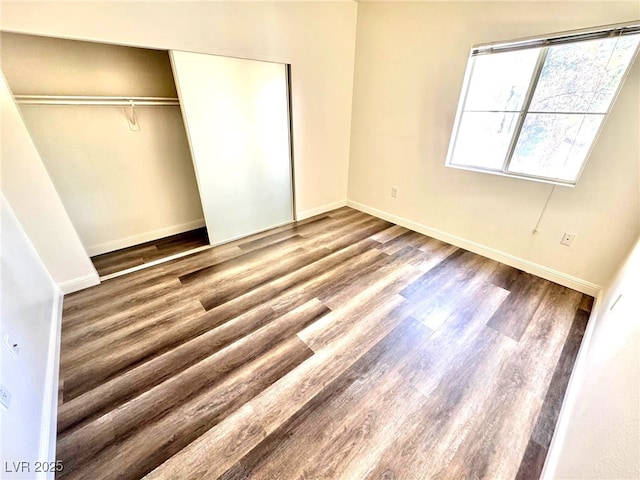 5250 S Rainbow Blvd Unit 2029, Las Vegas, NV 89118 - unfurnished bedroom with wood finished floors, baseboards, and a closet