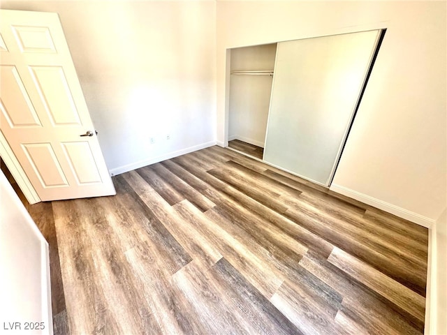 5250 S Rainbow Blvd Unit 2029, Las Vegas, NV 89118 - unfurnished bedroom featuring wood finished floors, baseboards, and a closet