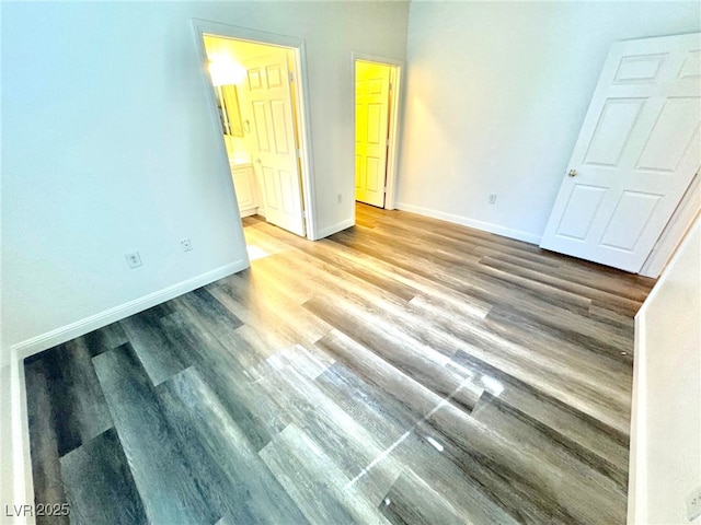 5250 S Rainbow Blvd Unit 2029, Las Vegas, NV 89118 - unfurnished bedroom with baseboards, wood finished floors, and ensuite bath