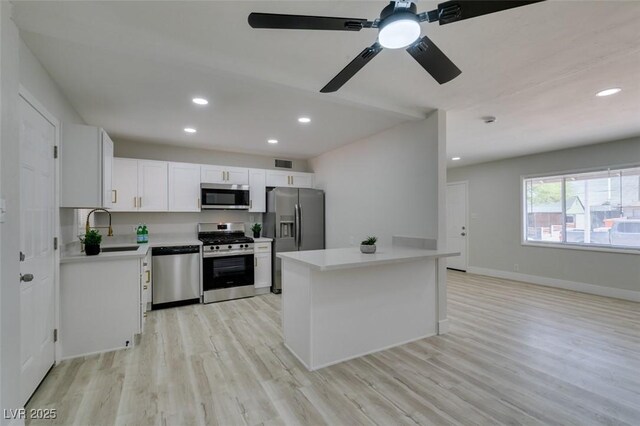 1825 Howard Ave, Las Vegas, NV 89104 - kitchen featuring stainless steel appliances, a sink, light wood-style floors, light countertops, and recessed lighting