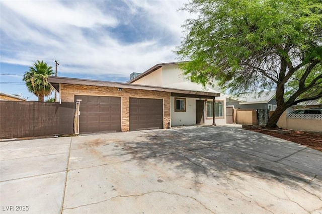 1806 Renada Cir, North Las Vegas, NV 89030 - view of front of home with a garage, stucco siding, and driveway