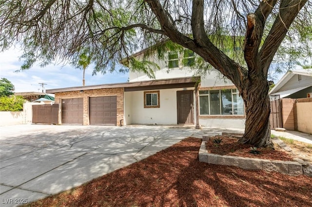 1806 Renada Cir, North Las Vegas, NV 89030 - view of front of house featuring stucco siding, a garage, and concrete driveway