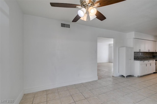 1806 Renada Cir, North Las Vegas, NV 89030 - kitchen with a ceiling fan, tasteful backsplash, white cabinetry, light tile patterned floors, and baseboards