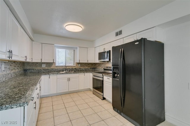 1806 Renada Cir, North Las Vegas, NV 89030 - kitchen featuring appliances with stainless steel finishes, white cabinets, and tasteful backsplash