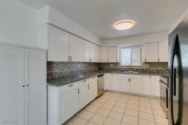 1806 Renada Cir, North Las Vegas, NV 89030 - kitchen with freestanding refrigerator, dishwasher, tasteful backsplash, a sink, and white cabinets