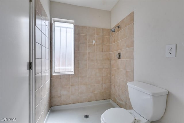 1806 Renada Cir, North Las Vegas, NV 89030 - bathroom featuring a tile shower, toilet, and healthy amount of natural light