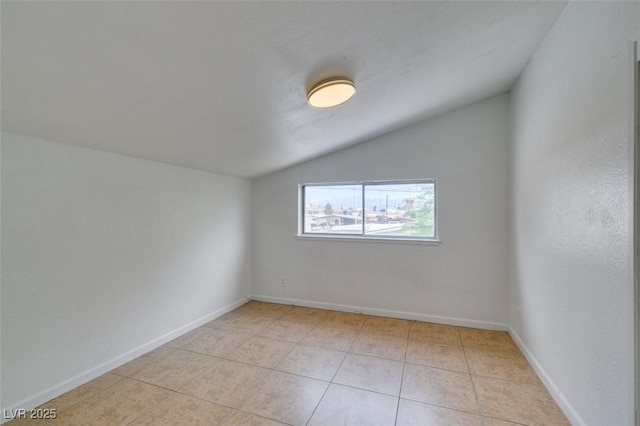 1806 Renada Cir, North Las Vegas, NV 89030 - empty room featuring vaulted ceiling, light tile patterned floors, and baseboards