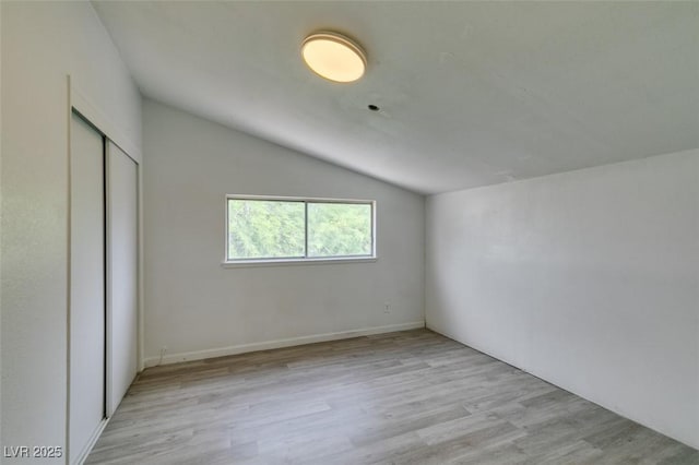 1806 Renada Cir, North Las Vegas, NV 89030 - unfurnished bedroom with lofted ceiling, light wood-type flooring, and a closet