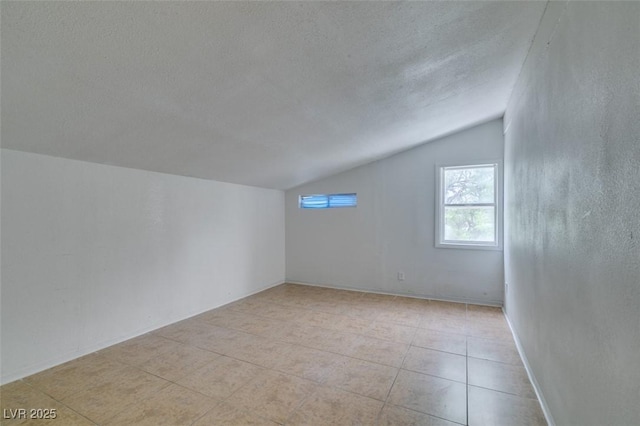 1806 Renada Cir, North Las Vegas, NV 89030 - additional living space with vaulted ceiling, a textured ceiling, and light tile patterned flooring