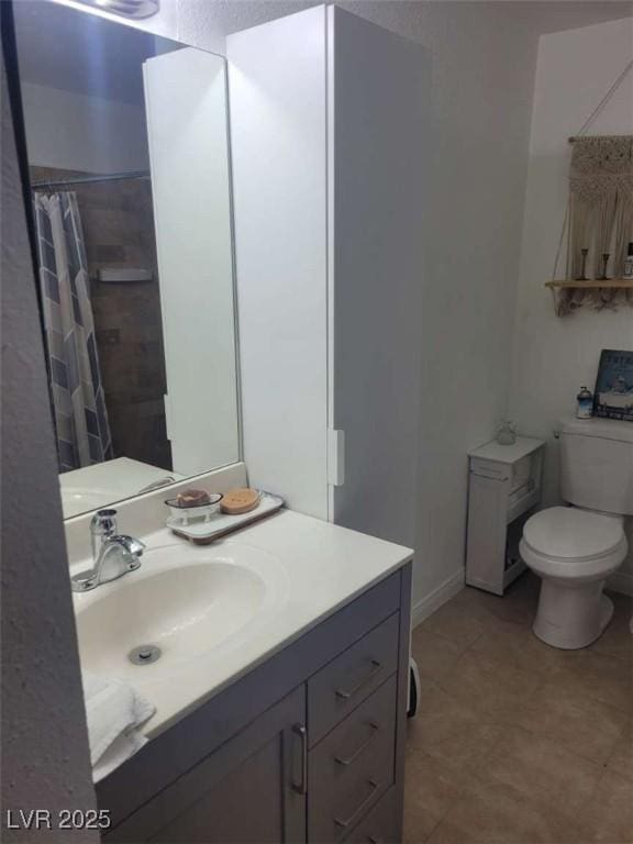 5335 Rod Ct Unit 102, Las Vegas, NV 89122 - bathroom with toilet, vanity, tile patterned floors, and a shower with curtain