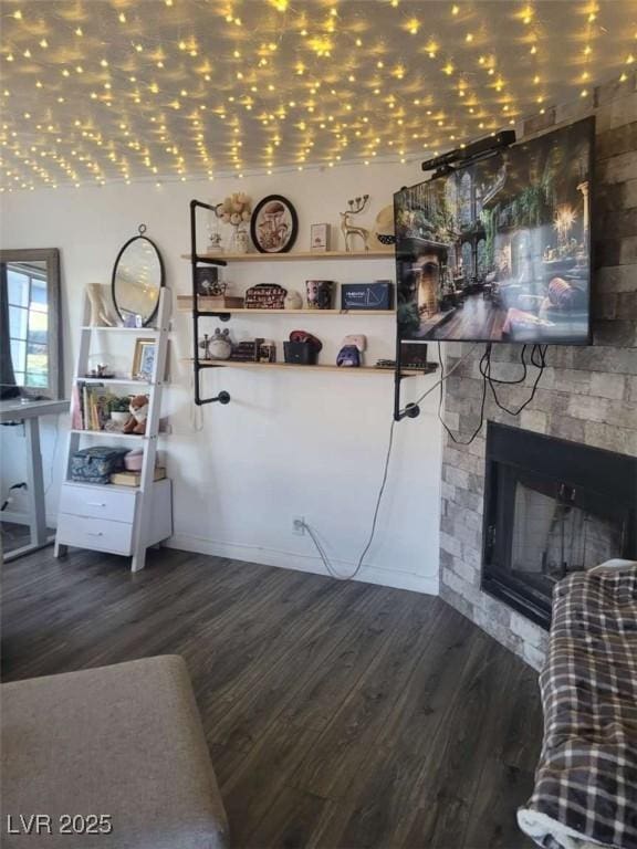 5335 Rod Ct Unit 102, Las Vegas, NV 89122 - living area featuring wood finished floors and a stone fireplace