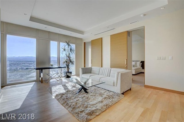 3750 S Las Vegas Blvd Unit 3111, Las Vegas, NV 89158 - living area with a raised ceiling, light wood-type flooring, and plenty of natural light